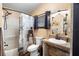 Traditional bathroom featuring a shower-tub combo, decorative curtain, and oval mirror over vanity at 1572 Darlington Ave, Deltona, FL 32725