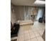Simple bedroom featuring a single bed, tiled floor, and ample natural light at 1572 Darlington Ave, Deltona, FL 32725