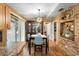 Dining area with modern lighting, a stylish table set, and convenient access to the kitchen at 1572 Darlington Ave, Deltona, FL 32725
