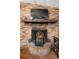Close-up of a charming brick fireplace with a decorative screen and wooden mantel at 1572 Darlington Ave, Deltona, FL 32725