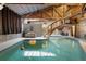 Stunning indoor pool area with unique architectural features, a staircase, and ambient lighting at 1572 Darlington Ave, Deltona, FL 32725