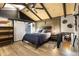 Modern bedroom with vaulted wood ceilings, wood-look flooring, and barn-style closet door at 1572 Darlington Ave, Deltona, FL 32725