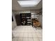 Functional workspace featuring a desk, chair, bookcase, and tile flooring, creating an efficient setup at 1572 Darlington Ave, Deltona, FL 32725