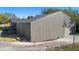 Home's rear exterior with a metal roof and backyard at 1572 Darlington Ave, Deltona, FL 32725