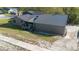 Rear view of home featuring a metal roof and driveway at 1572 Darlington Ave, Deltona, FL 32725