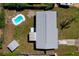 Aerial view showcasing the home, pool, storage shed, and well-kept backyard at 1609 Raleigh Ave, Daytona Beach, FL 32117