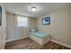 This bedroom features light walls, wood floors, and a twin bed with room for storage at 1609 Raleigh Ave, Daytona Beach, FL 32117