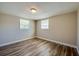 Empty bedroom featuring two windows that provide plenty of natural light and wood-look flooring at 1609 Raleigh Ave, Daytona Beach, FL 32117