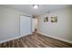 Bedroom showcasing wood floors, neutral walls, white trim, and a closet at 1609 Raleigh Ave, Daytona Beach, FL 32117
