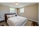 Bedroom featuring a plush bed, neutral tones, and ample natural light from two windows at 1609 Raleigh Ave, Daytona Beach, FL 32117