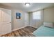 This bedroom features light walls, wood floors, and a twin bed with room for storage at 1609 Raleigh Ave, Daytona Beach, FL 32117
