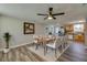 Open dining room with hardwood floors connecting to the kitchen with knotty pine cabinetry at 1609 Raleigh Ave, Daytona Beach, FL 32117