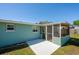 Charming exterior view of the home, highlighting the screened-in patio and well-maintained yard at 1609 Raleigh Ave, Daytona Beach, FL 32117