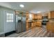 Well-lit kitchen featuring stainless steel appliances, knotty pine cabinetry and hardwood floors at 1609 Raleigh Ave, Daytona Beach, FL 32117