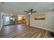 Spacious living room with hardwood floors connecting to the kitchen with knotty pine cabinetry at 1609 Raleigh Ave, Daytona Beach, FL 32117