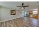 Spacious living room with hardwood floors connecting to the kitchen with knotty pine cabinetry at 1609 Raleigh Ave, Daytona Beach, FL 32117