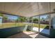 Relaxing screened-in patio with tile flooring, providing a tranquil view of the backyard and pool at 1609 Raleigh Ave, Daytona Beach, FL 32117