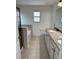 Bright bathroom featuring a dual sink vanity with granite countertops, tile flooring, soaking tub, and a window at 1812 Leather Fern Dr, Ocoee, FL 34761