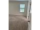 Neutral carpeted bedroom with window providing natural light and neutral paint at 1812 Leather Fern Dr, Ocoee, FL 34761