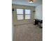 Neutral carpeted bedroom with two windows providing natural light and neutral paint at 1812 Leather Fern Dr, Ocoee, FL 34761