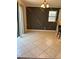 Open dining room with geometric accent wall, tile floors, and modern light fixture at 1812 Leather Fern Dr, Ocoee, FL 34761