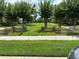 A grassy green space with various trees and beautiful landscaping at 1812 Leather Fern Dr, Ocoee, FL 34761