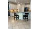 Open floorplan featuring a snack bar and kitchen, with granite countertops and white cabinetry at 1812 Leather Fern Dr, Ocoee, FL 34761