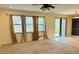 Bright living room with large windows, neutral carpet, and access to a patio at 1812 Leather Fern Dr, Ocoee, FL 34761