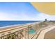 Balcony view overlooking the ocean, beach, and community pool at 1900 N Atlantic Ave # 504, Daytona Beach, FL 32118