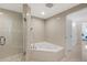 Modern bathroom with glass shower, soaking tub, and tiled walls at 1900 N Atlantic Ave # 504, Daytona Beach, FL 32118