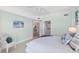 Relaxing bedroom features a cozy chair and decor, plus easy access to ensuite bathroom at 1900 N Atlantic Ave # 504, Daytona Beach, FL 32118