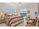 Bright bedroom featuring a king bed with a balcony and comfortable seating area at 1900 N Atlantic Ave # 504, Daytona Beach, FL 32118