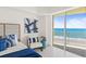 Bright bedroom features ocean view balcony, stylish decor, and natural light at 1900 N Atlantic Ave # 504, Daytona Beach, FL 32118