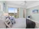 Bright bedroom with balcony access, a cozy chair, and comfortable bedding at 1900 N Atlantic Ave # 504, Daytona Beach, FL 32118