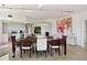 Dining room view showing the fireplace, artwork, and updated modern kitchen at 1900 N Atlantic Ave # 504, Daytona Beach, FL 32118