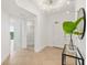 Foyer with stylish light fixture, tiled floor and plant accent at 1900 N Atlantic Ave # 504, Daytona Beach, FL 32118
