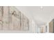 Hallway with decorative art and neutral walls leading to other rooms at 1900 N Atlantic Ave # 504, Daytona Beach, FL 32118