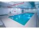 Inviting indoor pool with tile flooring, bright lighting, and easy access stairs to the cool, clear water at 1900 N Atlantic Ave # 504, Daytona Beach, FL 32118