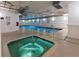 Relaxing indoor pool and jacuzzi area with tile flooring, bright lighting, and easy access to the cool, clear water at 1900 N Atlantic Ave # 504, Daytona Beach, FL 32118