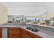 Modern kitchen with granite countertops and stainless steel appliances overlooking the living area at 1900 N Atlantic Ave # 504, Daytona Beach, FL 32118