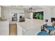 Modern kitchen featuring stainless steel appliances, a large island, and sleek white cabinetry at 1900 N Atlantic Ave # 504, Daytona Beach, FL 32118