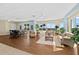 Spacious lounge area featuring hardwood floors, comfortable seating, and stunning ocean views through the expansive windows at 1900 N Atlantic Ave # 504, Daytona Beach, FL 32118