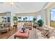 Bright living room with plush seating, elegant decor, and scenic beach views visible through large windows at 1900 N Atlantic Ave # 504, Daytona Beach, FL 32118