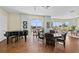 Comfortable lounge area with a piano, hardwood floors, table seating, and expansive windows showcasing outdoor views at 1900 N Atlantic Ave # 504, Daytona Beach, FL 32118