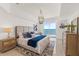 Beautiful main bedroom featuring cool colors, a chandelier and balcony access with an ocean view at 1900 N Atlantic Ave # 504, Daytona Beach, FL 32118