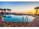 Community pool area with ocean views, palm trees, lounge chairs, and access to the beach at 1900 N Atlantic Ave # 504, Daytona Beach, FL 32118