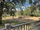Beautifully landscaped backyard with mature trees and fencing, providing privacy and a tranquil atmosphere at 1990 Spruce Creek N Cir, Port Orange, FL 32128