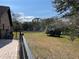 Well-maintained backyard with fencing and mature trees, offering a serene and private outdoor space at 1990 Spruce Creek N Cir, Port Orange, FL 32128