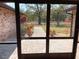 Screened-in porch view overlooking the backyard with a walkway, mature trees, and beautiful landscaping at 1990 Spruce Creek N Cir, Port Orange, FL 32128