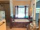 Elegant bathroom featuring a soaking tub and a separate glass-enclosed shower at 1990 Spruce Creek N Cir, Port Orange, FL 32128